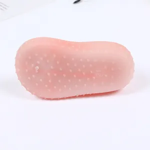 Detail view of the pink soft-bottom baby walking shoe sole with anti-slip texture dots