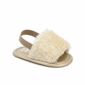Soft fuzzy baby sandals with elastic strap for infant pre-walkers in gold.
