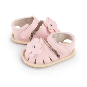Detailed view of pink infant sandals with soft flower decoration and velcro strap