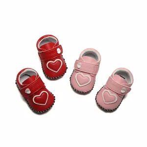 Vue détaillée des chaussures de marche souples pour bébé rouges et roses avec cœur