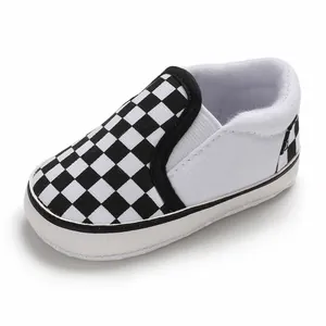 Close-up of baby slip-on walker shoes with classic black and white checkerboard pattern