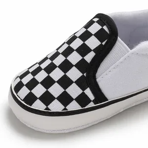Detailed close-up showing the checkerboard pattern and soft sole of this baby slip-on shoe.