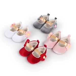 Detailed view of colorful velvet baby princess shoes with gold straps and flowers