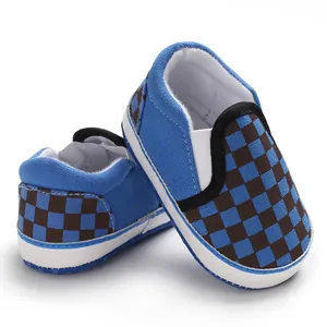 Detailed close-up of blue and brown checkered baby slip-on walking shoes with soft soles