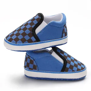 Side view of blue checkerboard canvas baby walker shoes with soft non-slip soles for infants