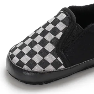 Macro view of checkered pattern and toe cap on soft-sole baby slip-on shoe.