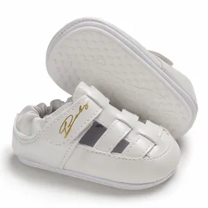 Close-up of white baby walking sandals with closed-toe design and anti-slip rubber sole