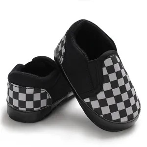 Detailed view of black and white checkerboard baby slip-on toddler shoes with soft soles