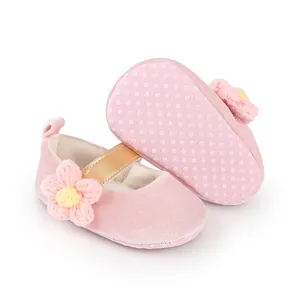 Detailed view of pink baby girl walking shoes featuring knitted flower and anti-slip rubber sole
