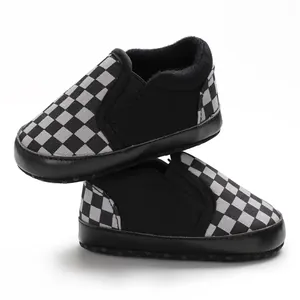 Close-up view of black and white checkerboard pattern on soft-soled baby walker shoes