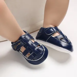 Detail of dark blue baby sandals with anti-slip rubber sole and velcro strap closure