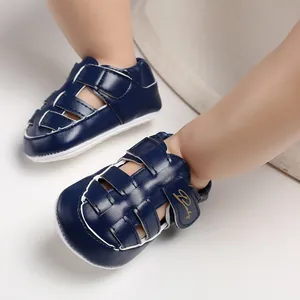 Close-up detail of navy blue closed-toe baby walking sandals with non-slip rubber soles.