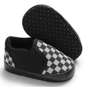 Detailed view of baby slip-on shoes with black and white checkered pattern and soft sole