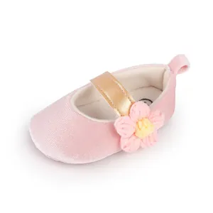 Detailed view of pink velvet baby princess shoe with gold strap and flower detail