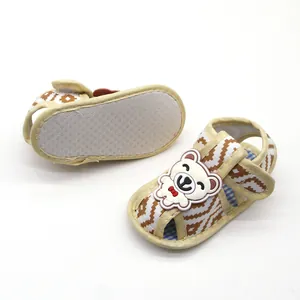 Detailed view of baby soft sole sandals featuring a cute cartoon bear and zigzag pattern.