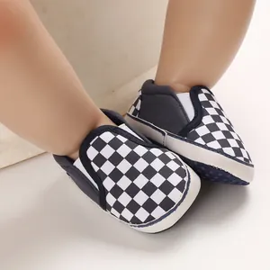 Close-up detail of baby checkerboard slip-on walking shoes with a soft flexible sole