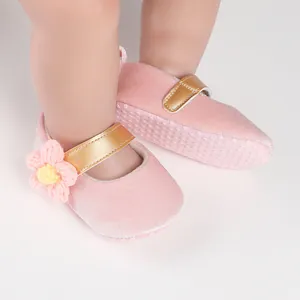 Pink velvet baby walker shoes with gold strap and crochet flower detail for infants.