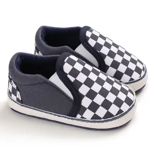 Detailed view of navy blue infant slip-on toddler shoes with black and white checkerboard pattern