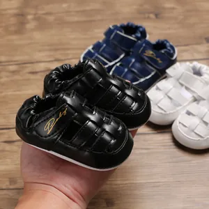 Close-up view of stylish black baby sandals featuring a comfortable closed-toe design