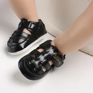 Detail view of black baby closed-toe sandals featuring non-slip rubber soles for infants