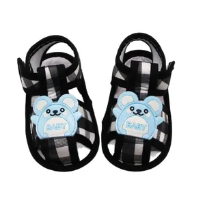 Soft-soled black and white plaid newborn baby sandals with a cute blue cartoon patch