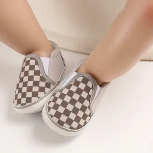 Detailed view of brown and white checkered baby slip-on walker shoes with soft soles
