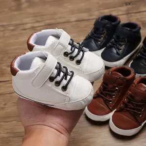 Close-up of white high-top leather baby pre-walker shoes featuring a soft sole and velcro strap