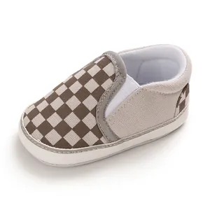 Detail view of brown checkerboard slip-on baby walking shoes with soft sole