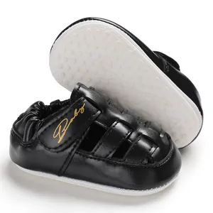 Detailed close-up view of black baby walking sandals featuring anti-slip white rubber soles