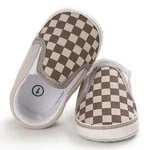 Close-up detail of tan and white checkerboard pattern on soft sole baby walker shoes
