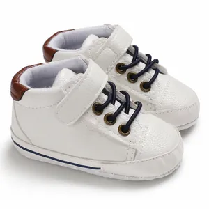 Detailed view of white high-top faux leather baby walker shoes with soft soles and straps