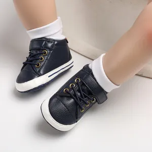 Detailed macro shot of navy blue pebbled leather high-top baby pre-walker shoes on feet