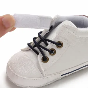 Close-up of white high-top leather baby walker shoe showing velcro strap detail