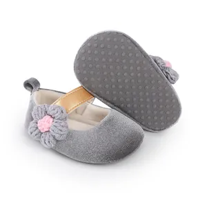 Detail showing the non-slip sole and velvet texture of the grey baby princess shoe