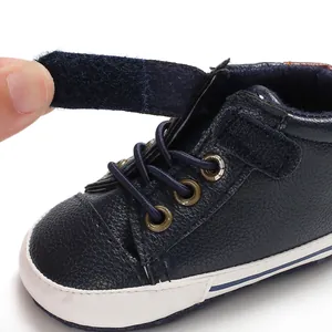 Detail shot of the hook-and-loop strap on the navy blue leather infant walking shoe
