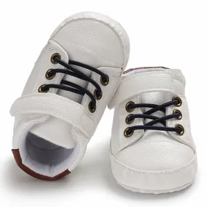 Macro view showing the soft leather texture of white high-top baby walking shoes
