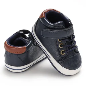 Detailed view of navy blue high-top leather baby walking shoes with soft white soles