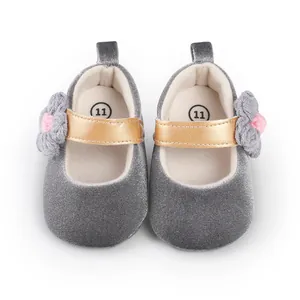 Detailed top view of baby girl gray velvet Mary Jane shoes with knit flower accent