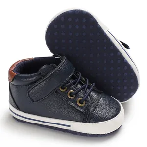 Close-up of navy blue high-top baby walking shoes with soft dot-patterned soles