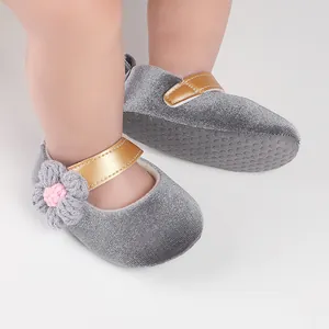 Detail of grey velvet baby girl walker shoes with gold strap and crochet flower accent