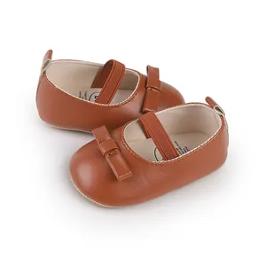 Detaillierte Makroaufnahme von braunen Baby-Mary-Jane-Schuhen aus Leder mit Schleifen