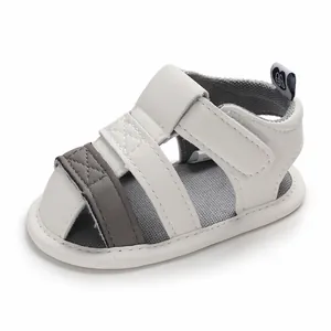 White and grey soft sole baby walking sandals with velcro closure for 0-1 year olds.