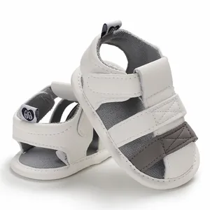 Detailed view of white baby summer sandals featuring a soft sole and secure Velcro straps.