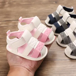 Detailed macro view of soft-soled baby sandals for infants, featuring a pink and white design.