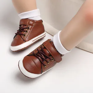 Detail view of brown leather high-top baby walking shoes with soft soles for infants.
