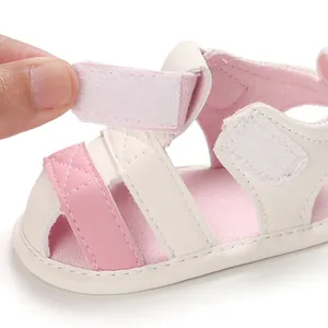 Close-up detail showing the adjustable Velcro strap on pink soft-sole baby summer sandals.