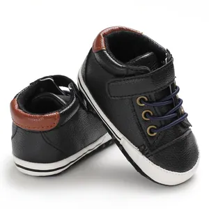 Detailed view of black high-top faux leather baby walking shoes with soft soles