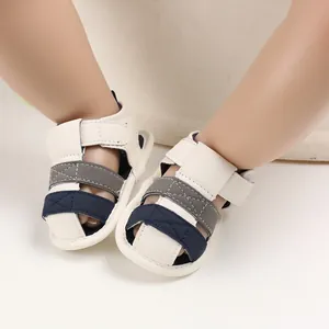 Close-up of baby summer sandals with soft sole and navy blue color block detail