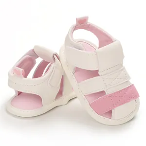 Detailed view of white and pink infant summer sandals with soft soles and hearts
