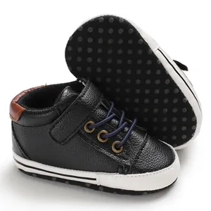 Detailed view of black high-top baby walking shoes showing textured non-slip soft soles